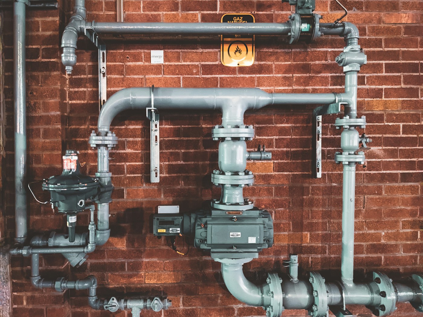 Professional plumber fitting modern pipework